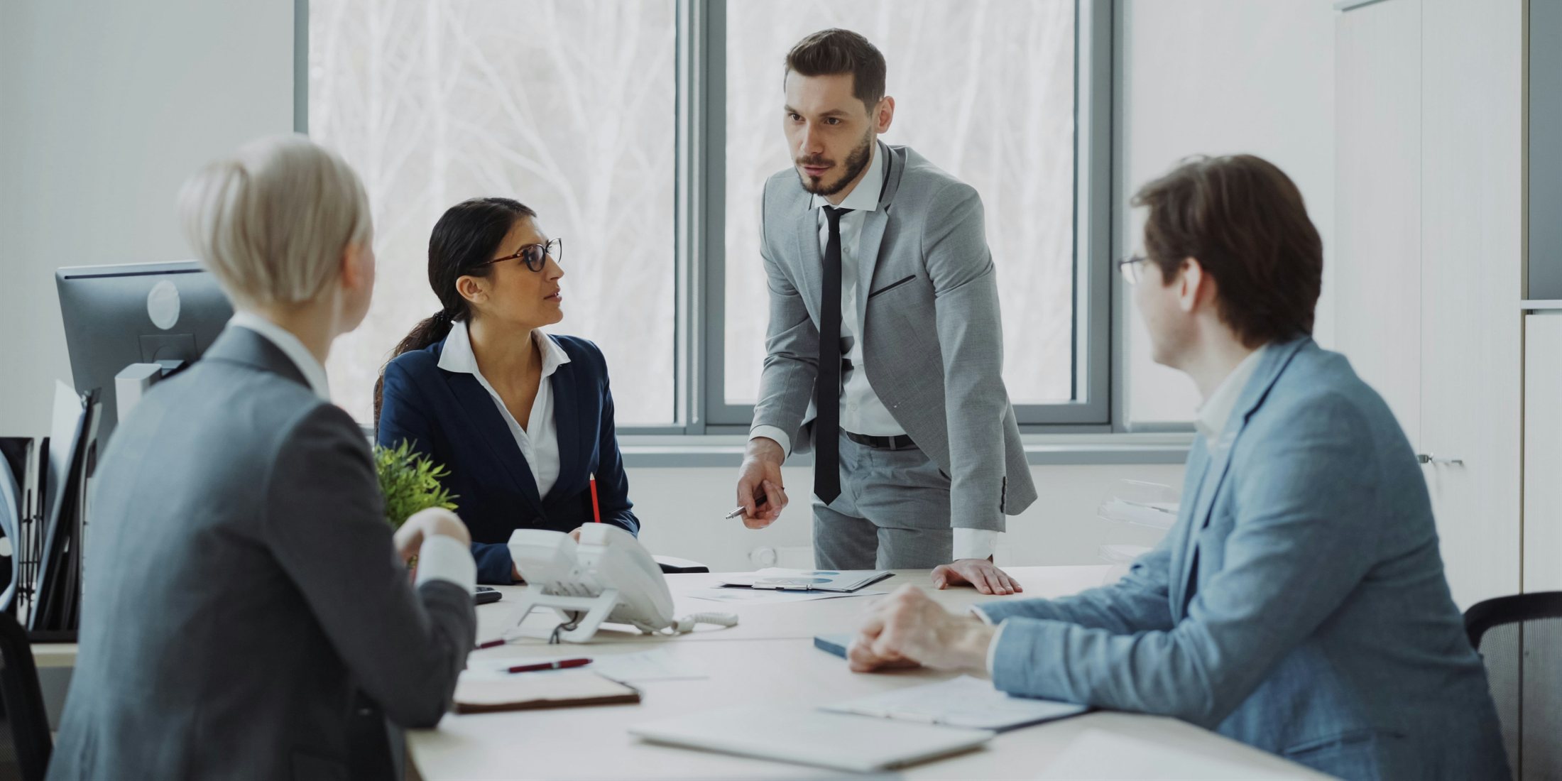 A deal team reviewing information around a conference table