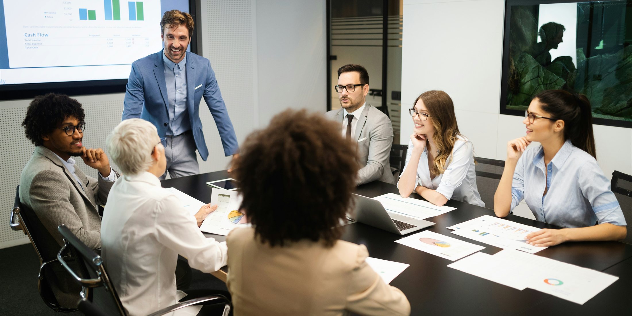 An investment team discussing portfolio information in a meeting
